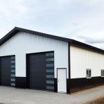 Black and white pole barn exterior showcasing classic design against Kentucky countryside